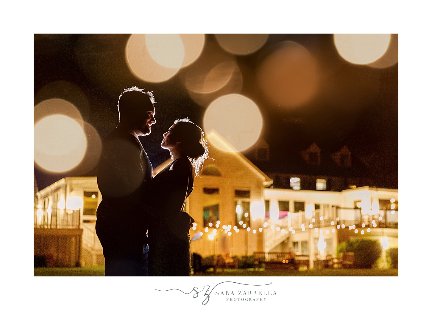 bride and groom smile at each other during nighttime portraits at Warwick Country Club