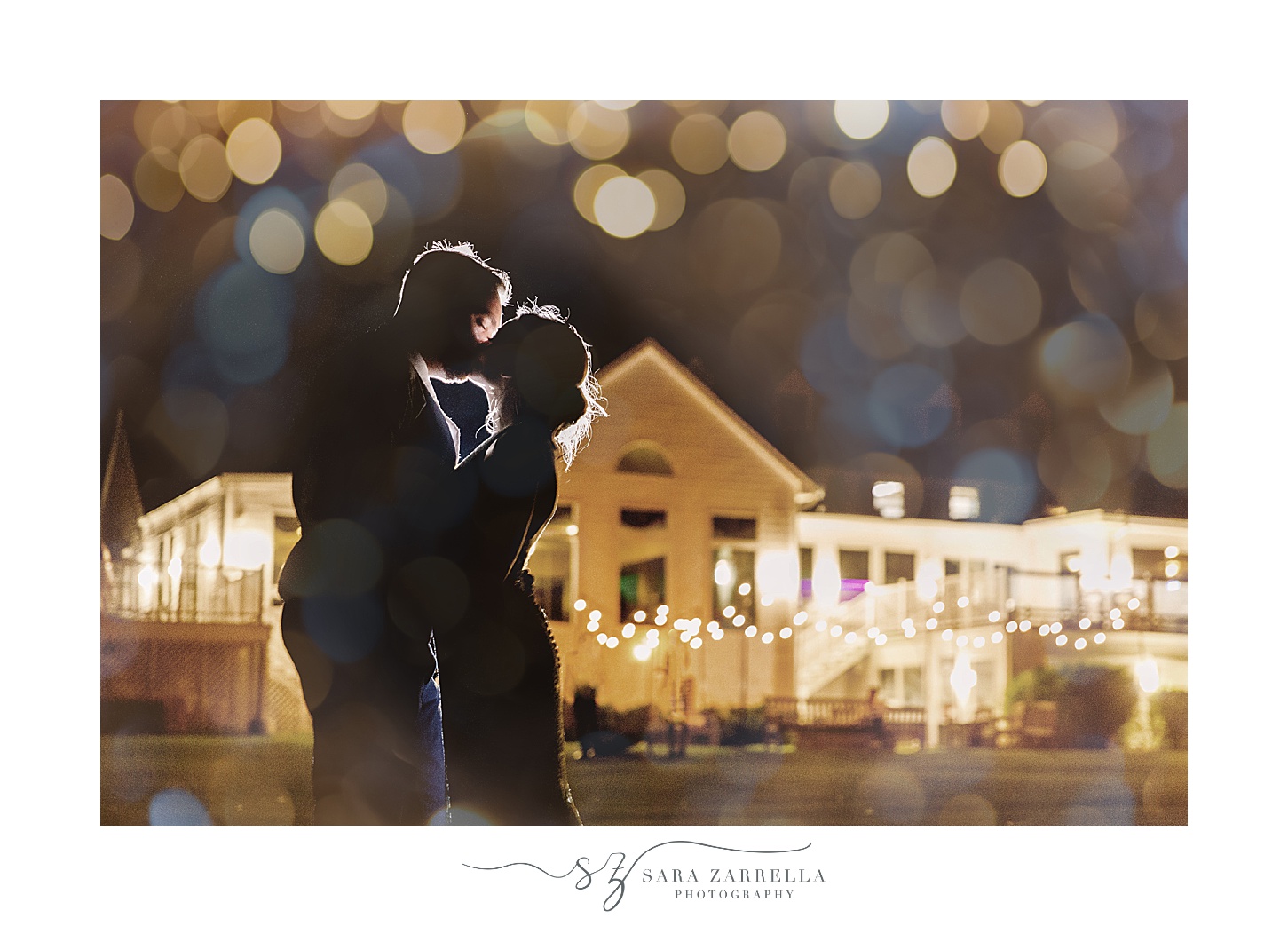 bride and groom kiss outside Warwick Country Club at dark