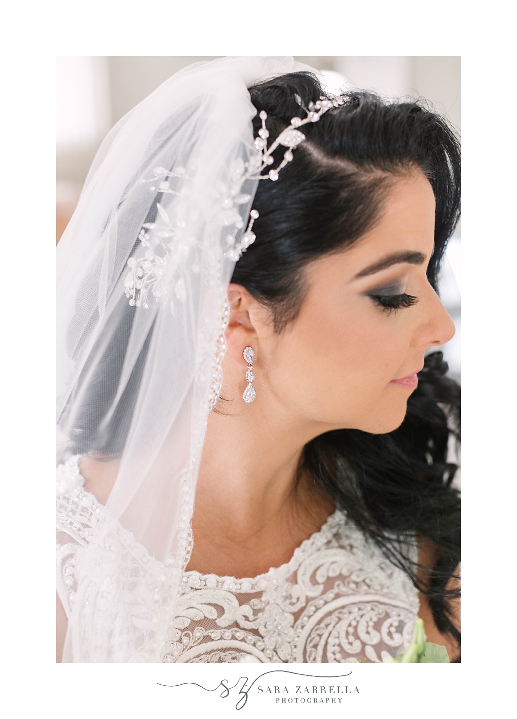 bride looks over shoulder showing off veil and hairpiece 