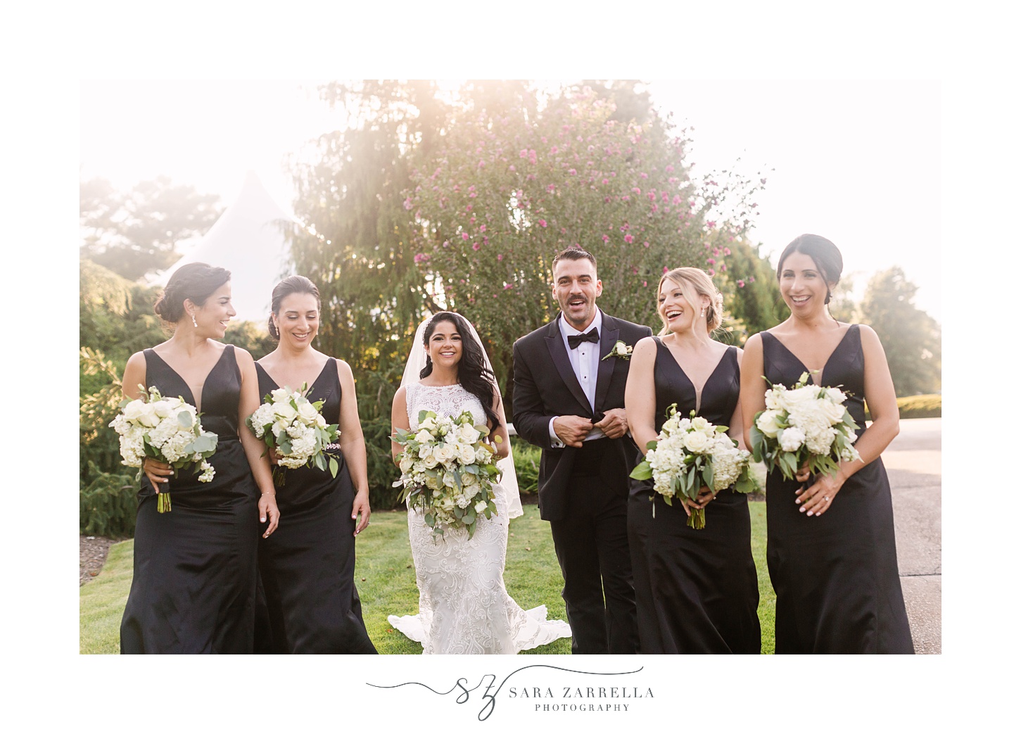 bride walks with bridesmaids and bridesman at Quidnessett Country Club