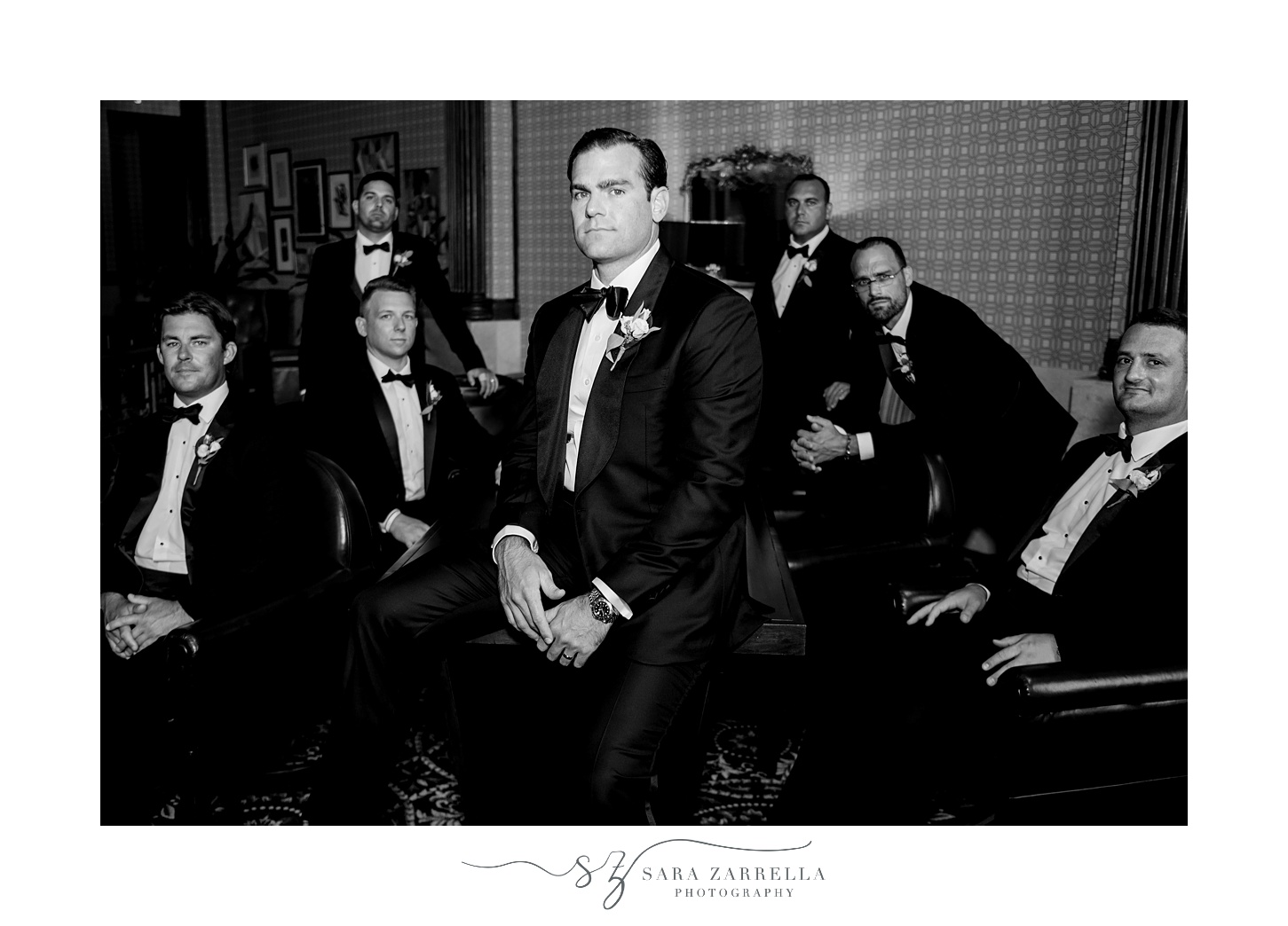 groomsmen pose around groom at  Quidnessett Country Club