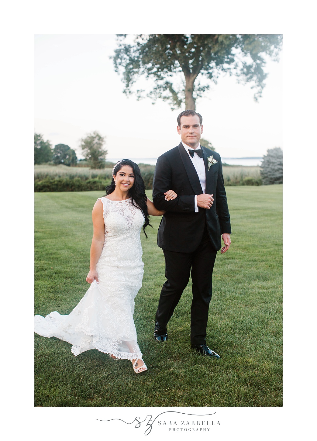 groom walks with bride on his arm at  Quidnessett Country Club