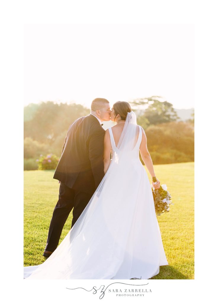 bride and groom kiss during wedding portraits at Atlantic Resort at Wyndham Newport