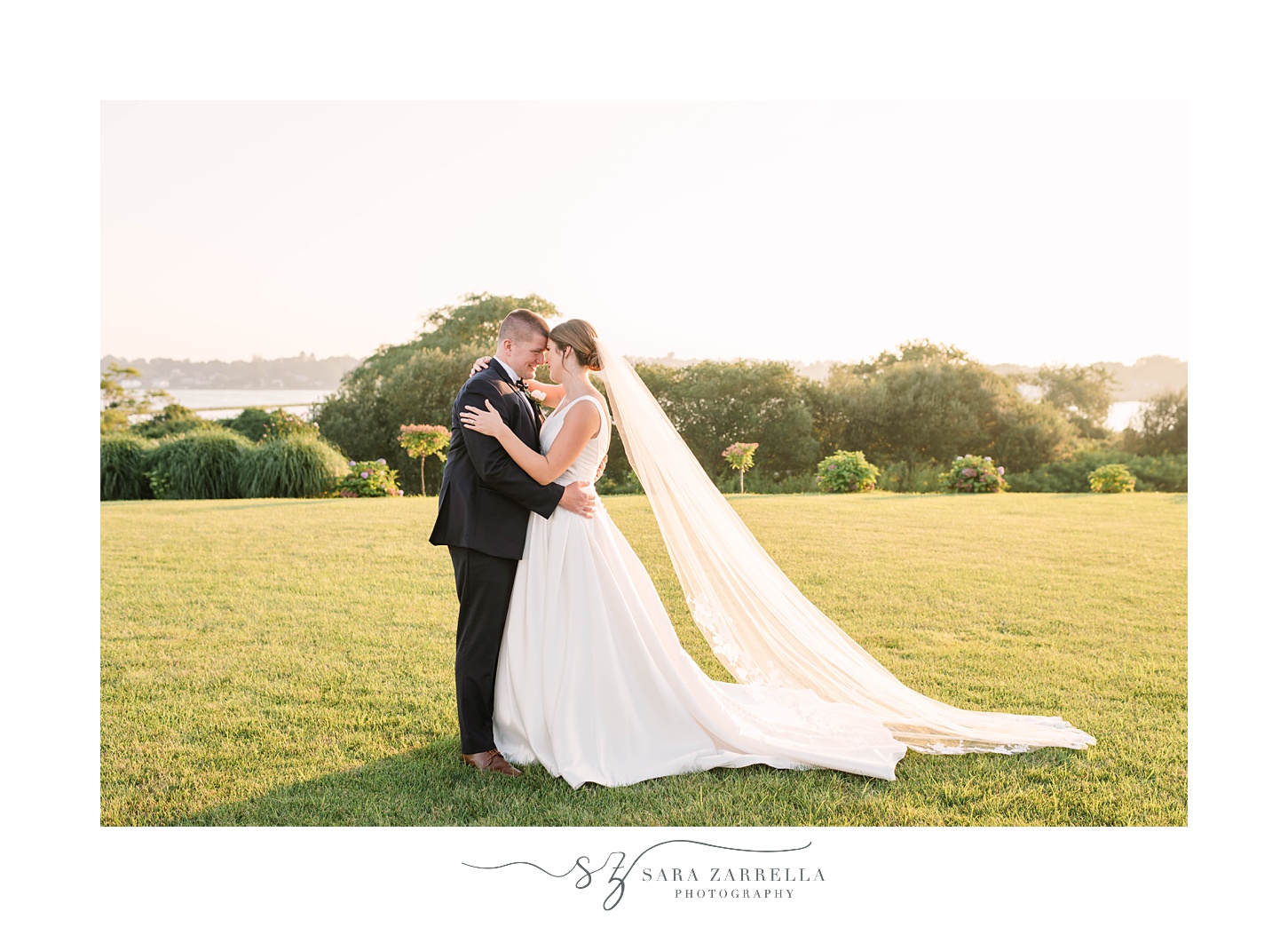 bride and groom stand with noses touching during Newport RI wedding portraits