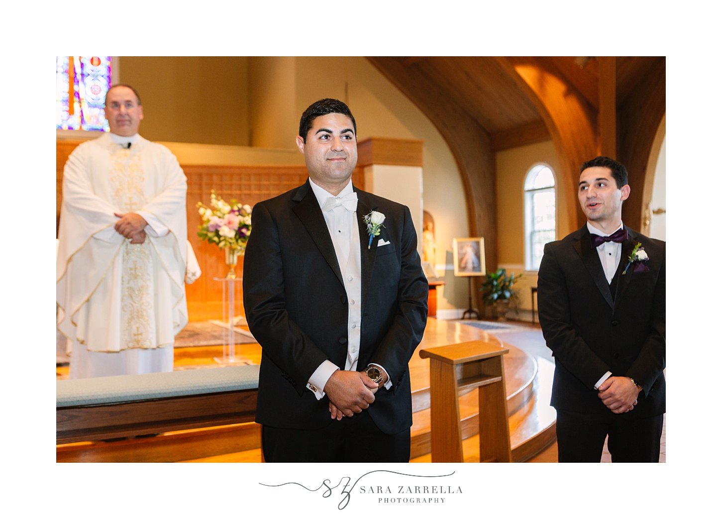 groom tears up looking at bride during traditional wedding ceremony in Rhode Island church