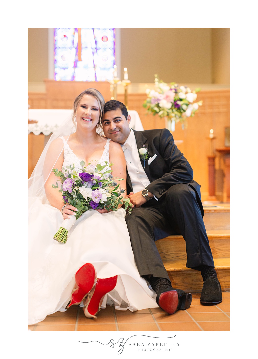 bride and groom sit together in church after traditional wedding ceremony in Rhode Island church