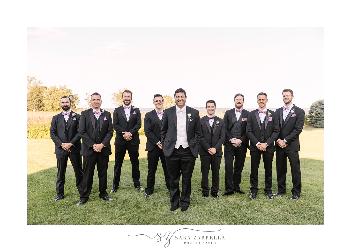 groom and groomsmen stand outside Quidnessett Country Club