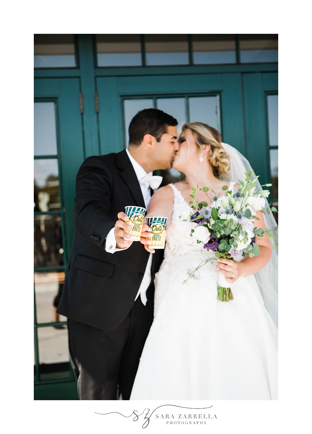 newlyweds kiss holding Del's Lemonade
