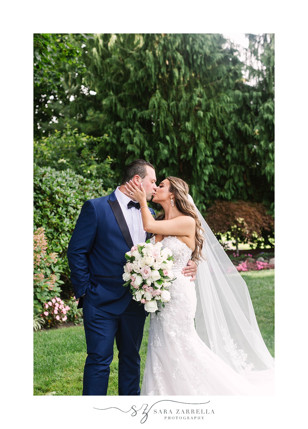 newlyweds kiss during portraits at Kirkbrae Country Club