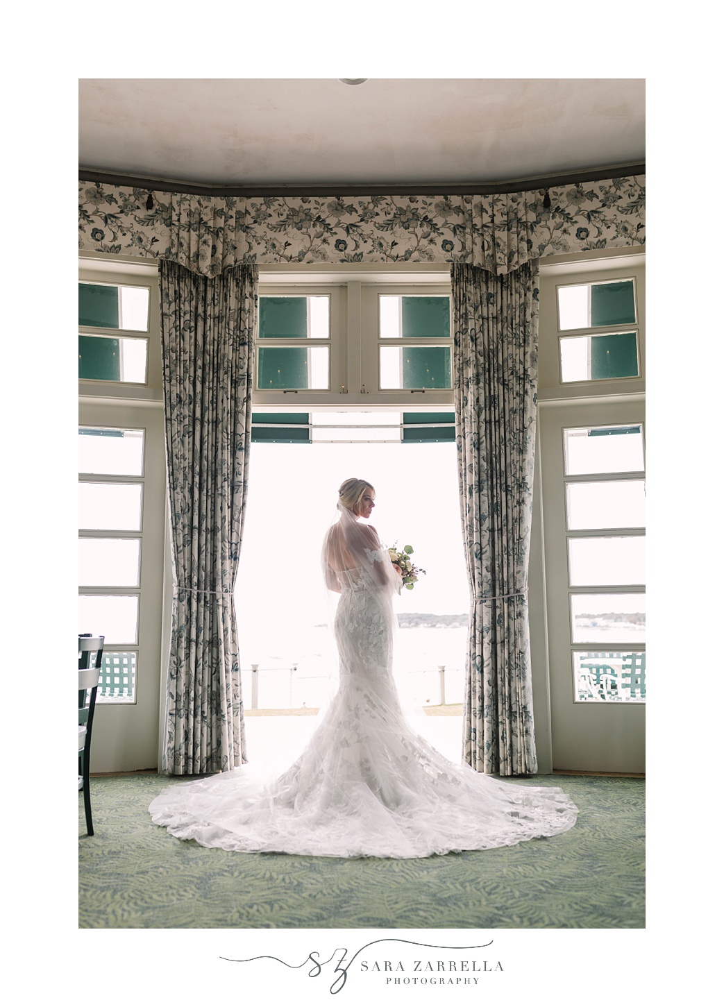 bride poses by window at The Dunes Club