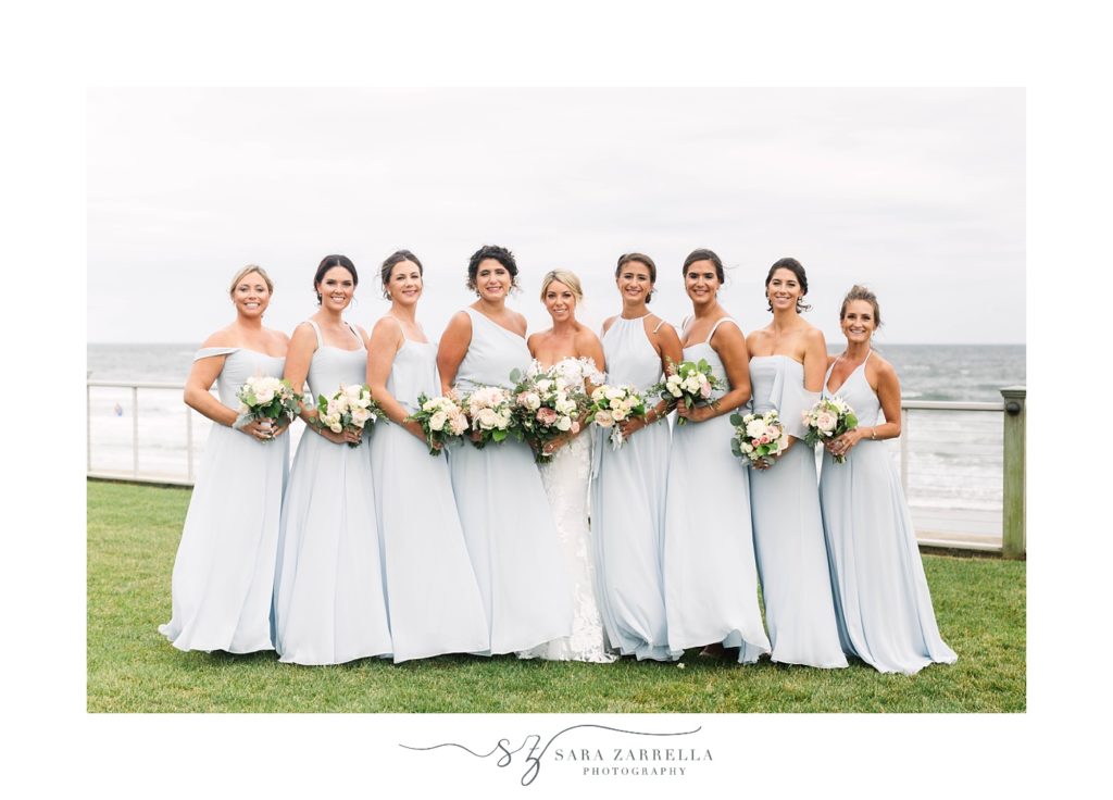 brides pose in light blue gowns in front of Narragansett Bay