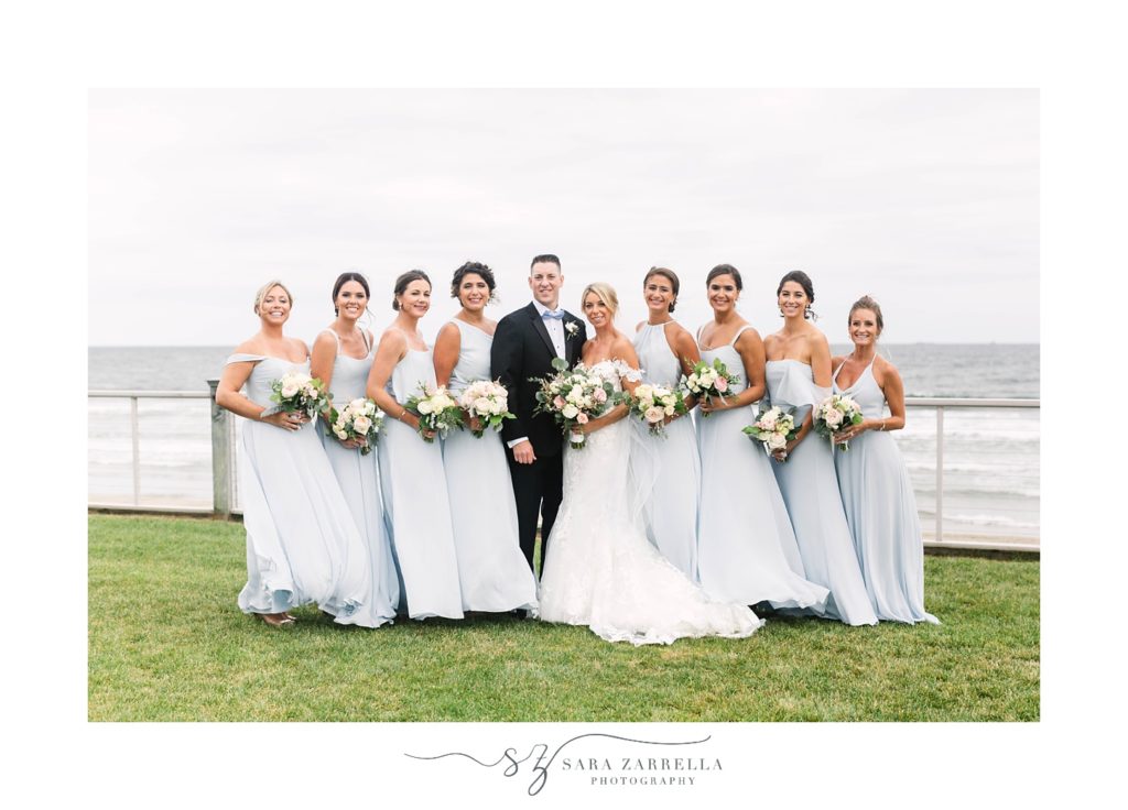 bride poses with bridesmaids and bridesman in front of Narragansett Bay