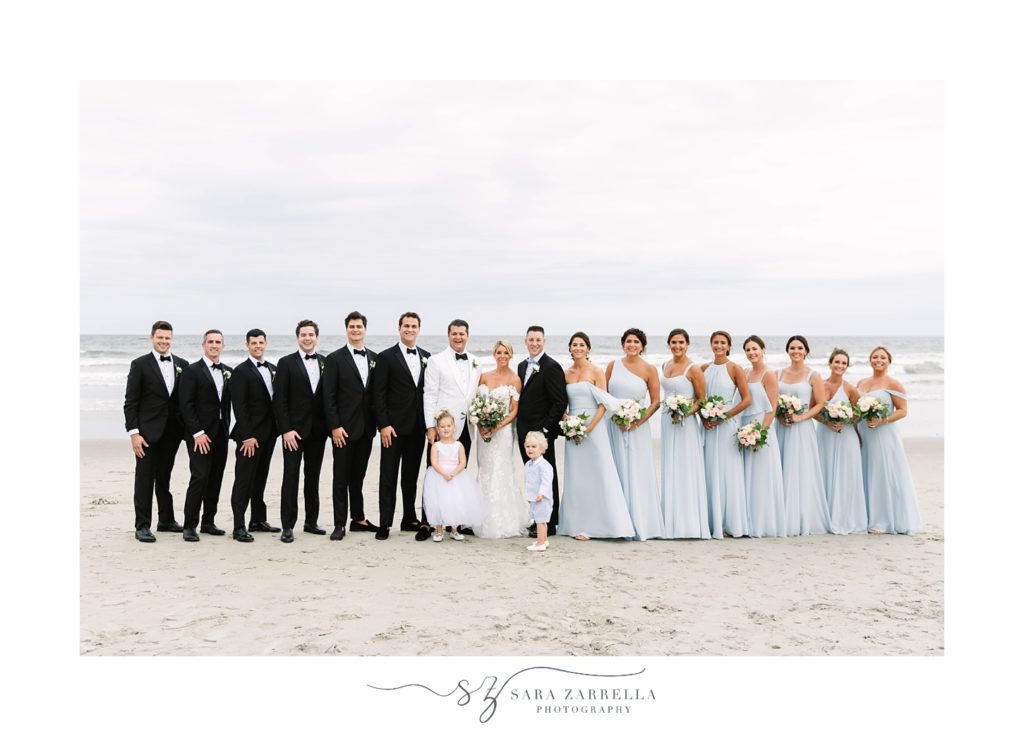newlywed pose with entire wedding party along Narragansett Bay