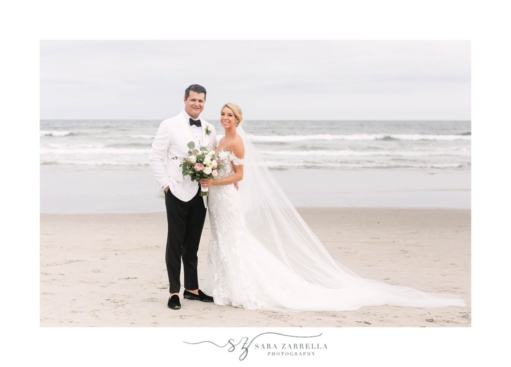 newlyweds pose by waterfront along Narragansett Bay