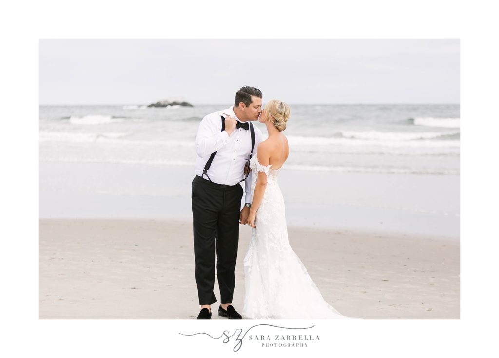 bride and groom kiss on waterfront at Narragansett Bay