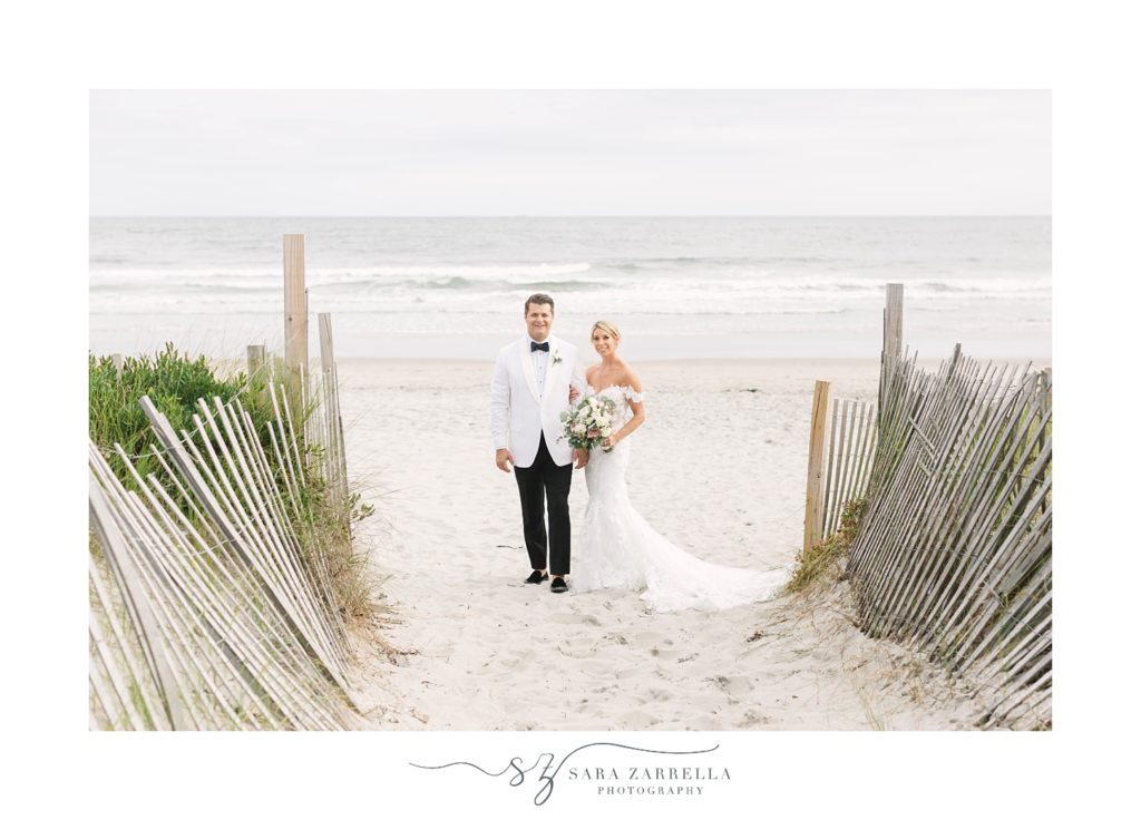 newlyweds pose on the beach in Rhode Island