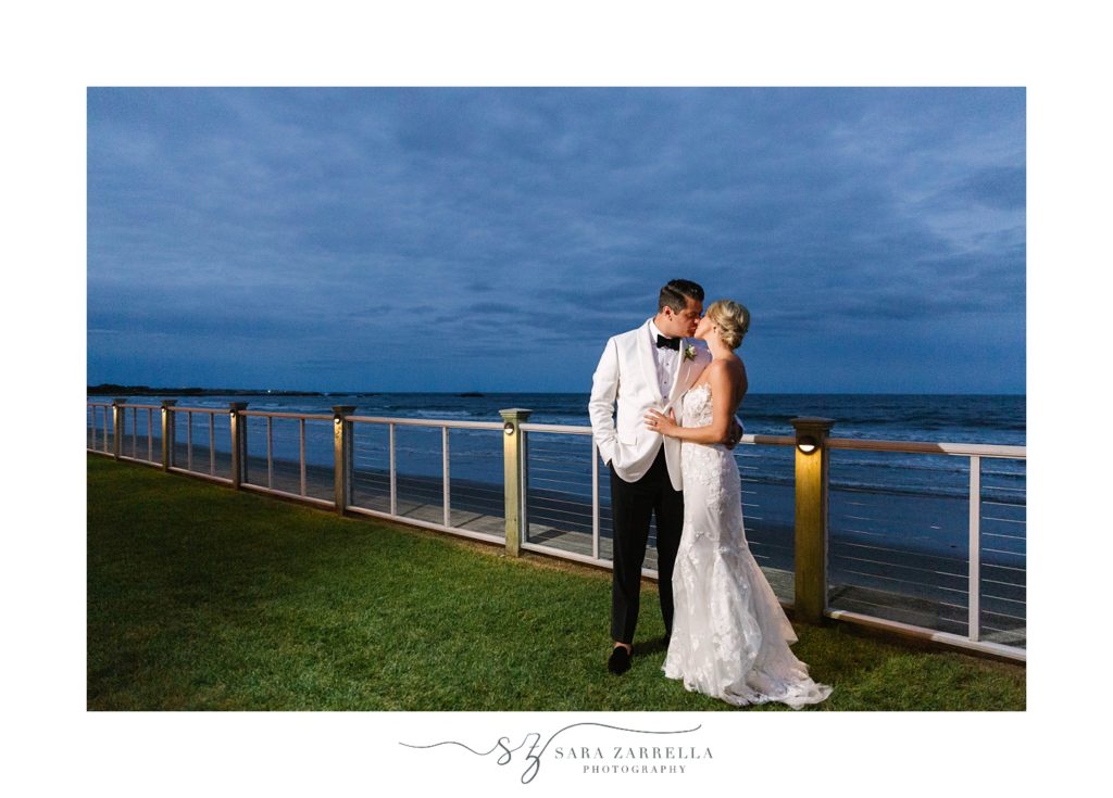 nighttime wedding portrait outside The Dunes Club along the bay