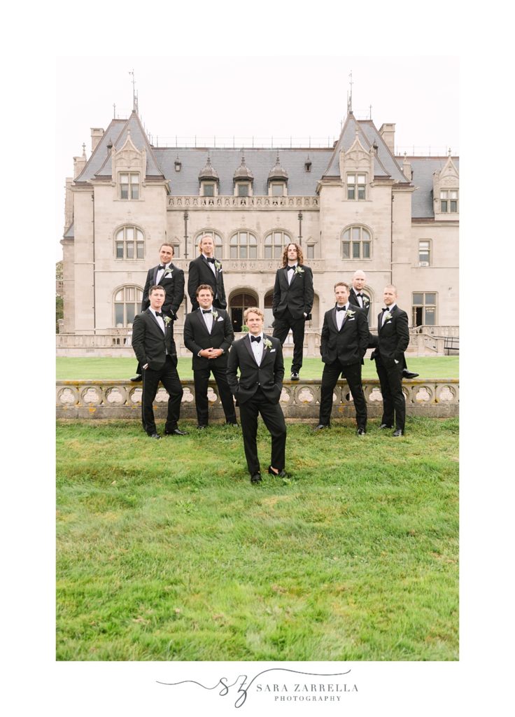 groom and groomsmen stand on steps at Ochre Court