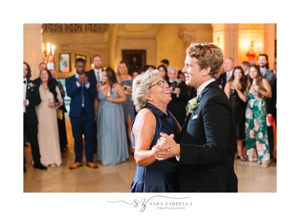 groom and mom dance together during wedding reception in Rhode Island 