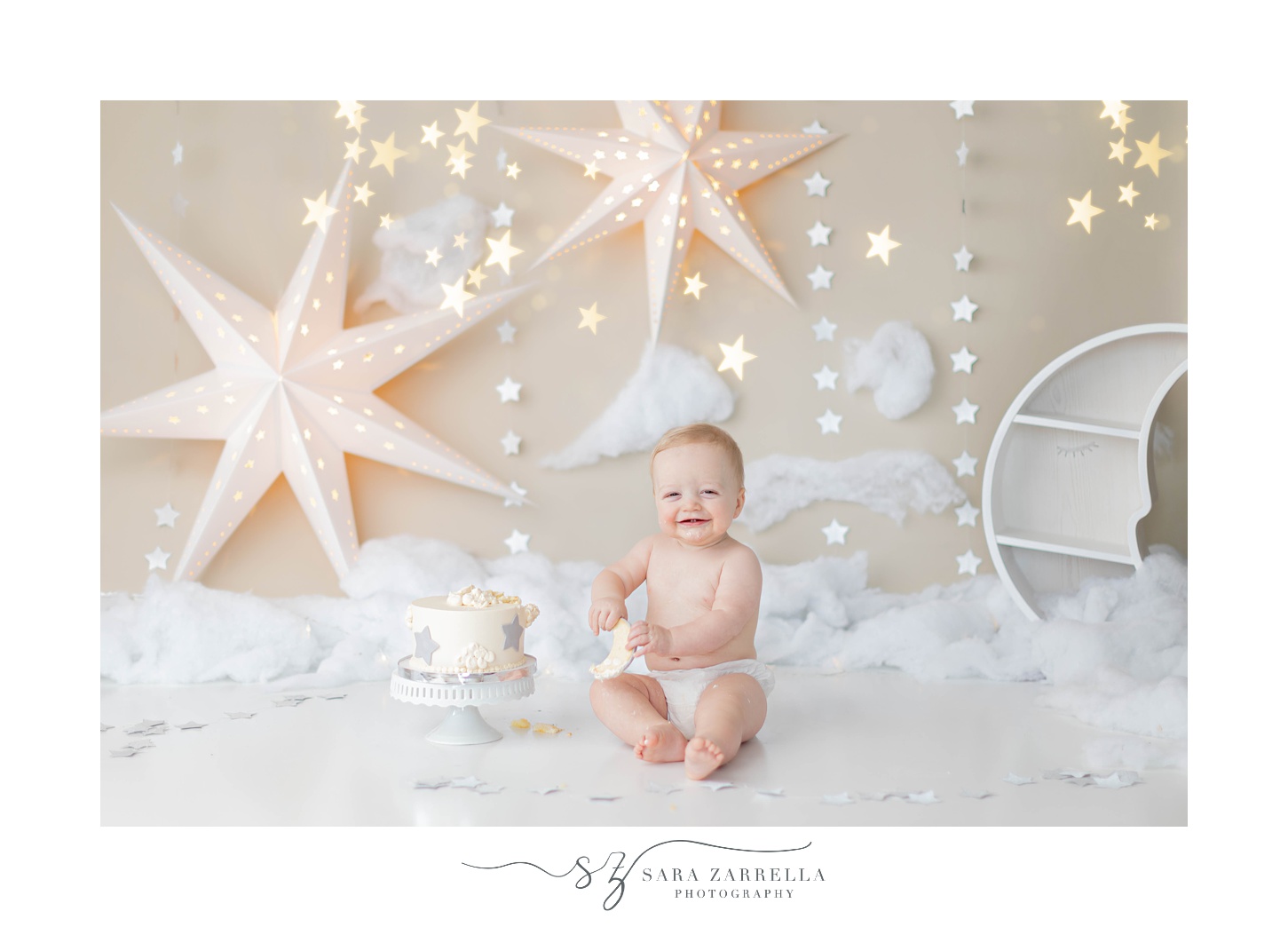baby plays with cake during first birthday photo shoot 