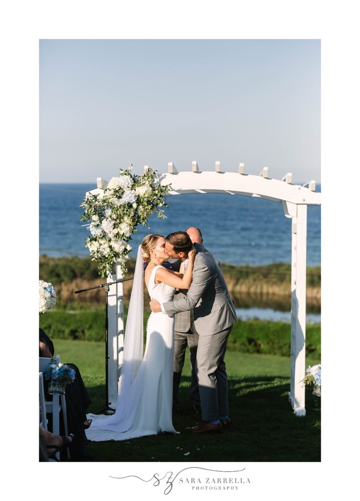 couple kisses during Spring House Hotel wedding ceremony on Block Island