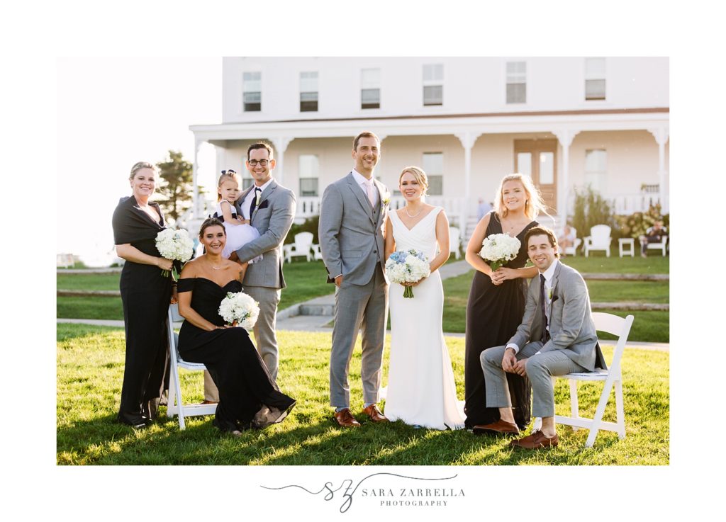 couple stands with bridal party outside the Spring House Hotel