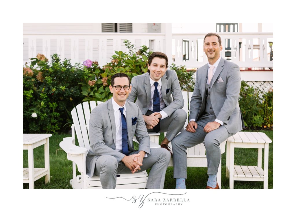 groom and groomsmen pose together outside the Spring House Hotel in grey suits