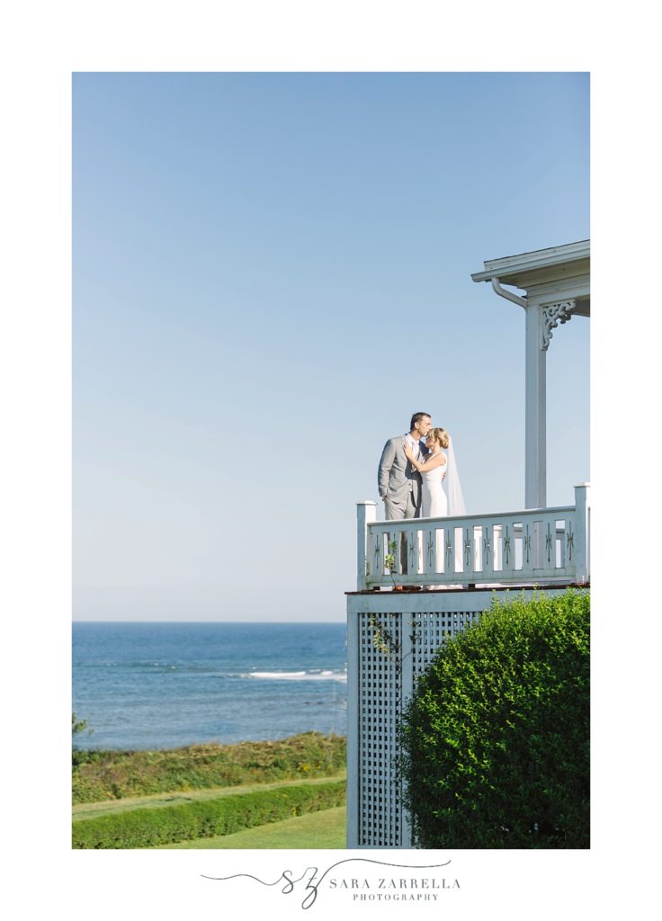 couple stands on balcony at the Spring House Hotel on Block Island 