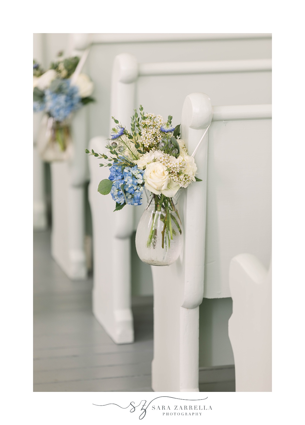 church pews with white and blue flowers