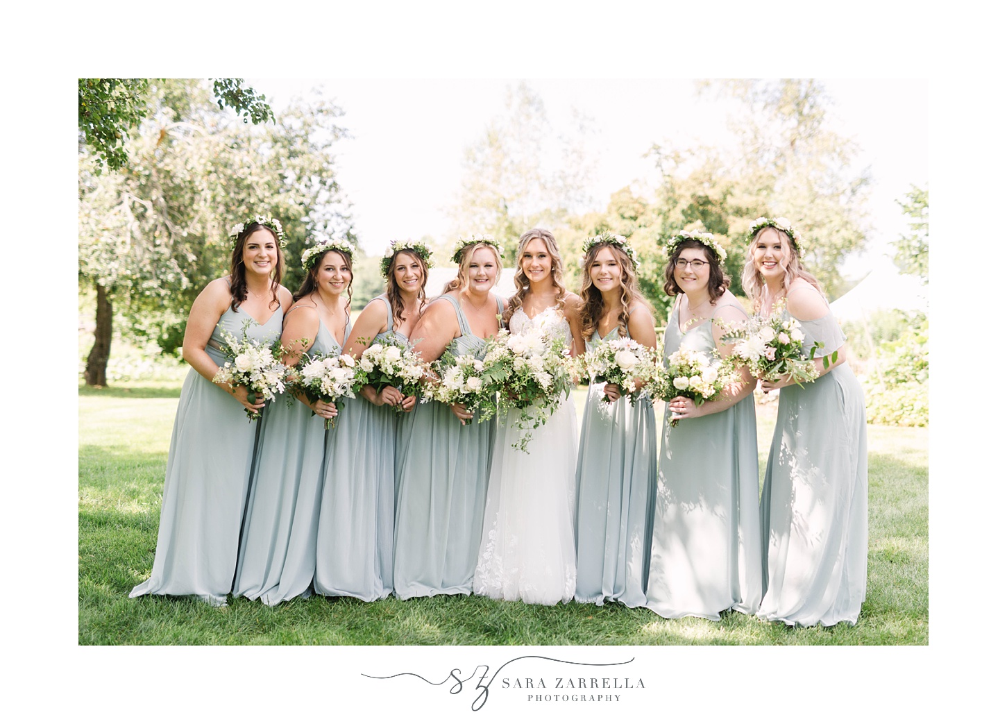 bride and bridesmaids pose in pastel green gowns