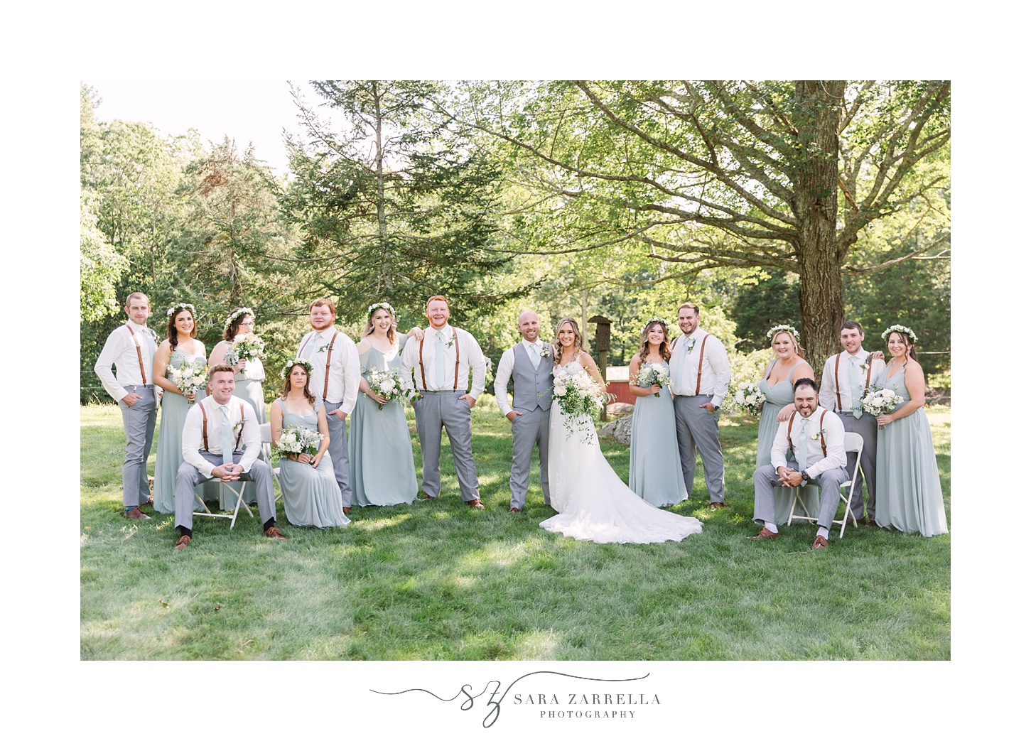 couple poses with wedding party during whimsical garden wedding