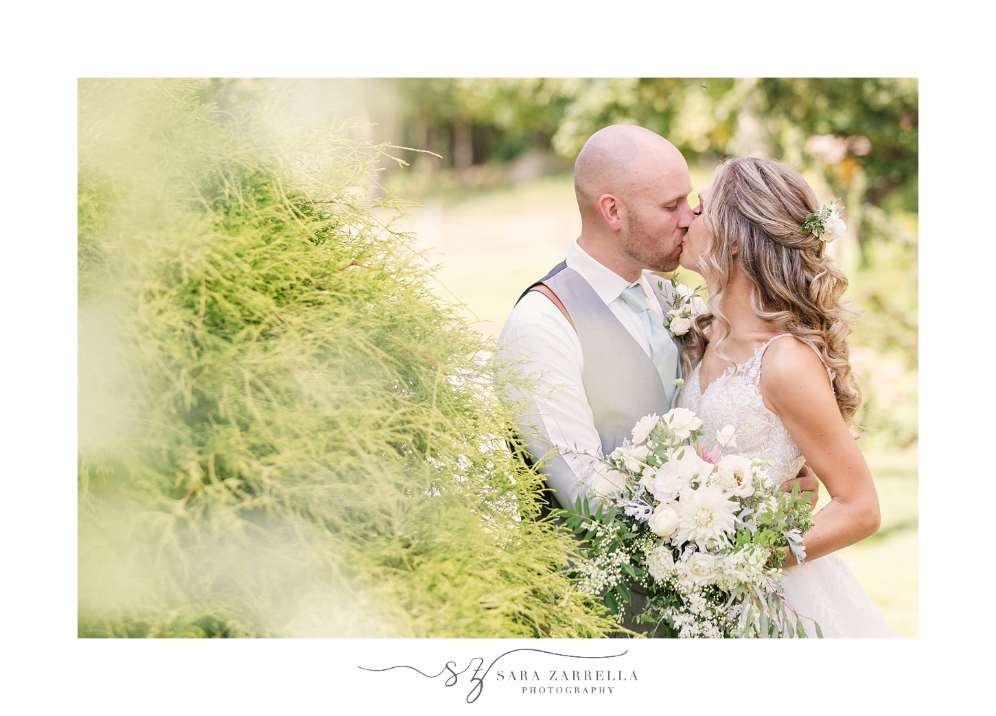 bride and groom kiss during whimsical garden wedding photos