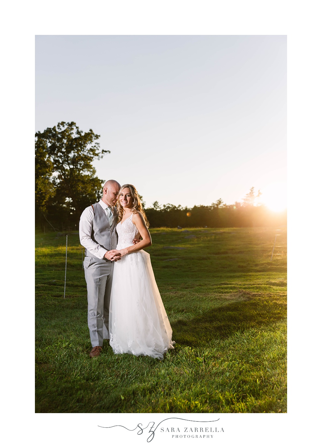 bride and groom hold hands together at sunset