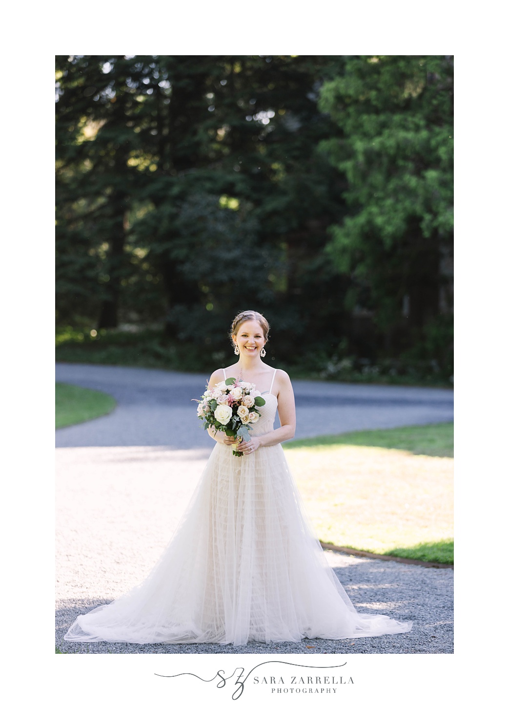 bride poses in strapless wedding gown at Blithewold Mansion