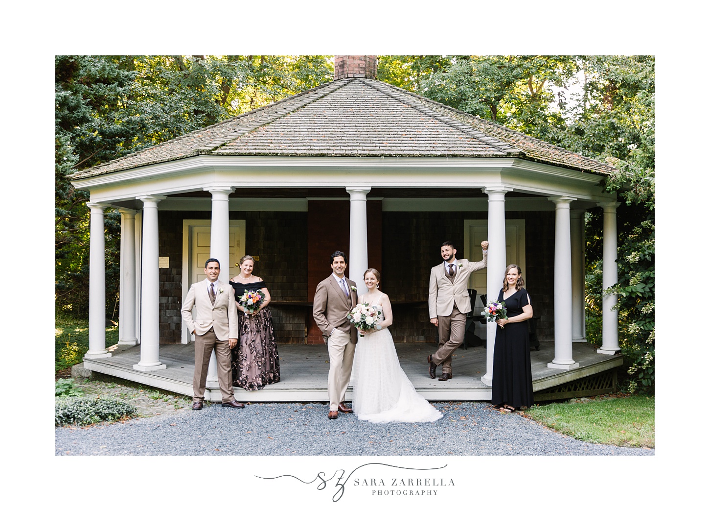 bride and groom pose with bridal party at gazebo at Blithewold Mansion