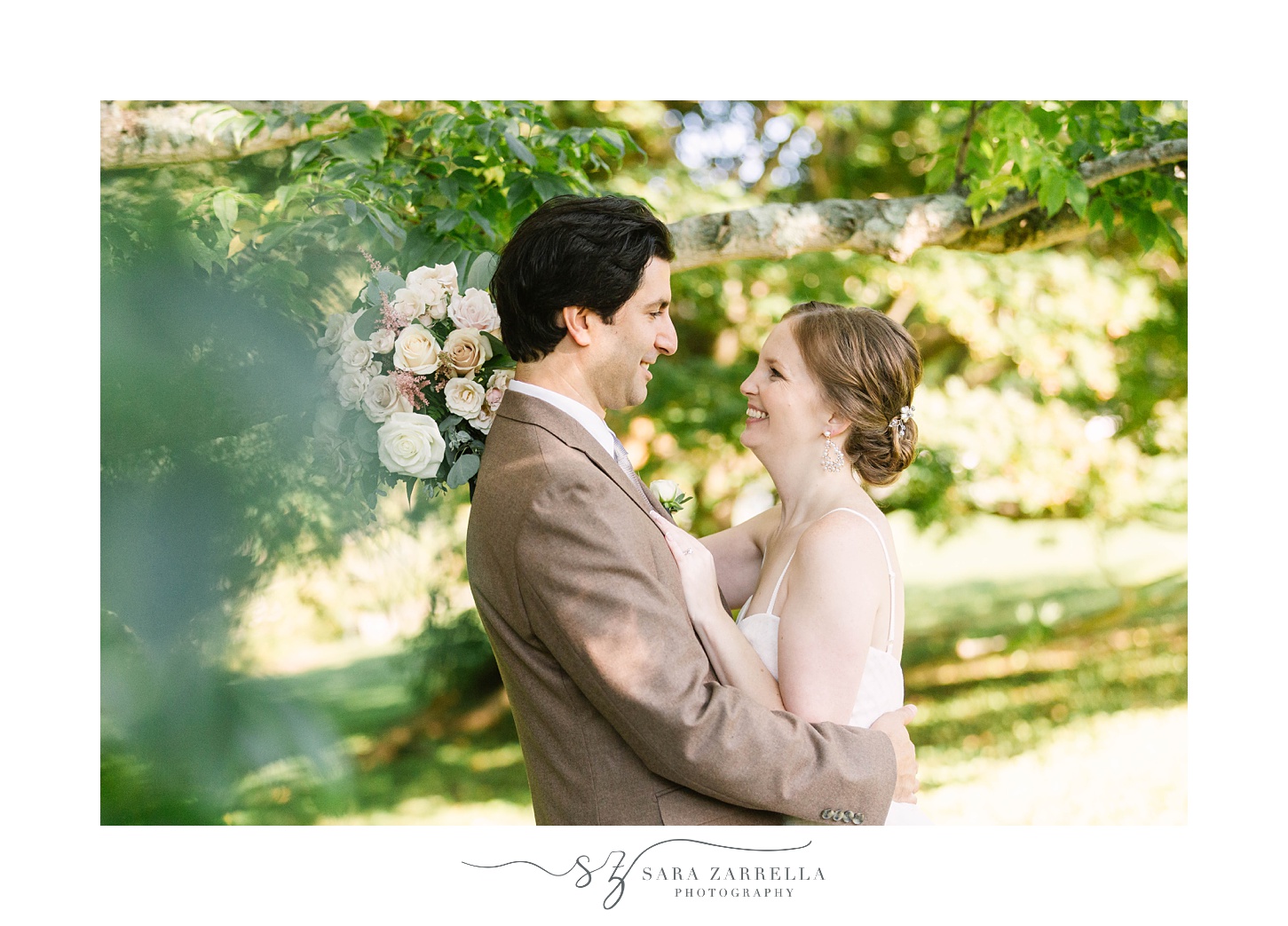 couple hugs in woods during wedding photos at Blithewold Mansion