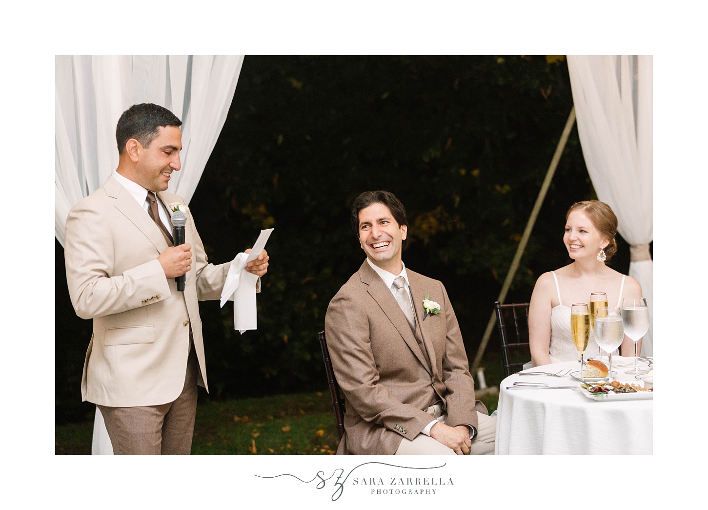 groomsman reads speech during wedding reception
