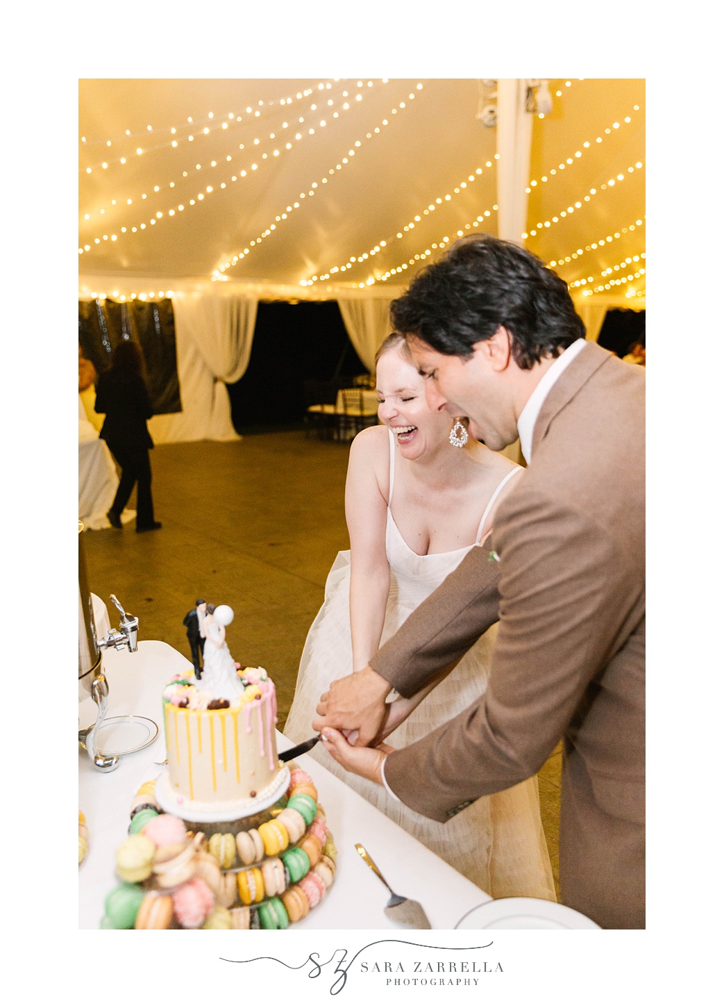couple cuts wedding cake during RI wedding reception
