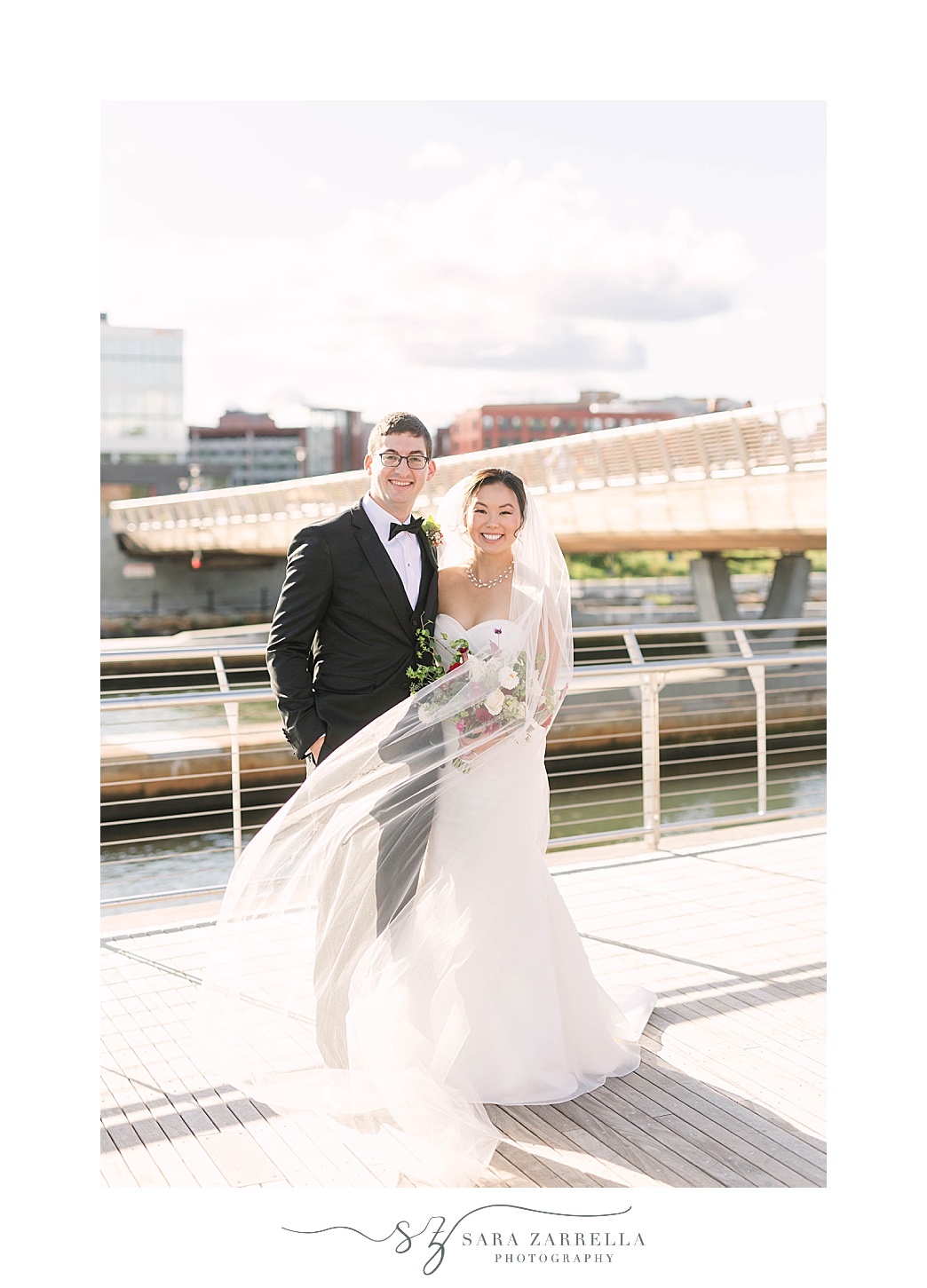 newlyweds pose on bridge after Downtown Providence wedding ceremony 