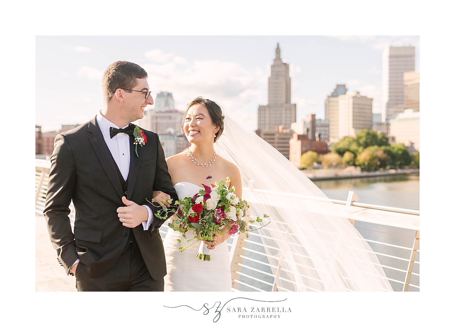 bride and groom walk over bridge in Providence RI