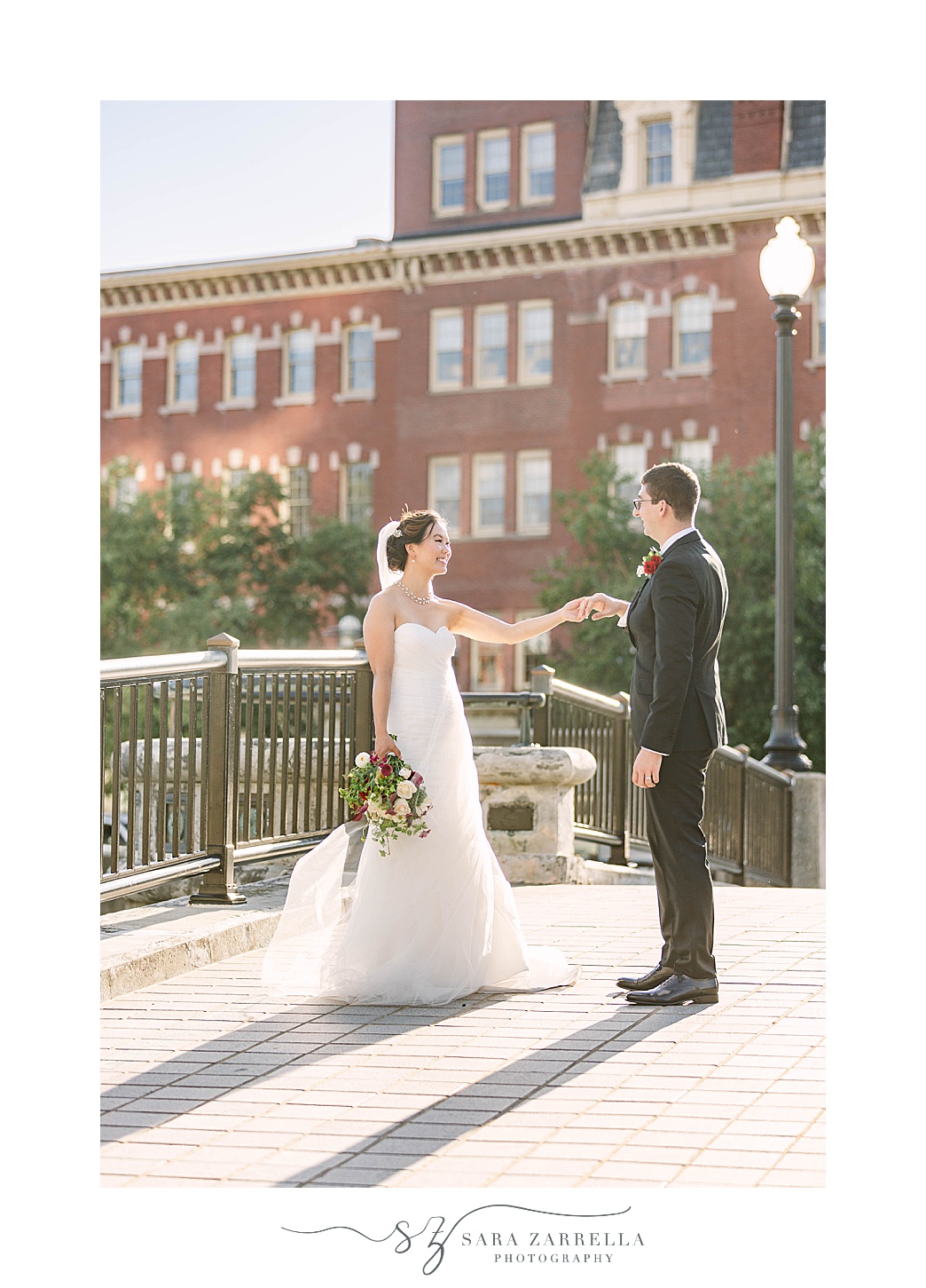 newlyweds walk on bridge in Downtown Providence