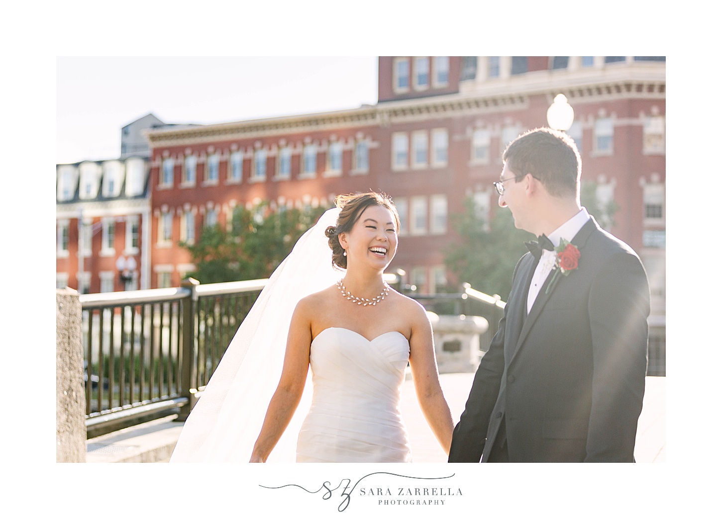 bride and groom laugh together in Downtown Providence