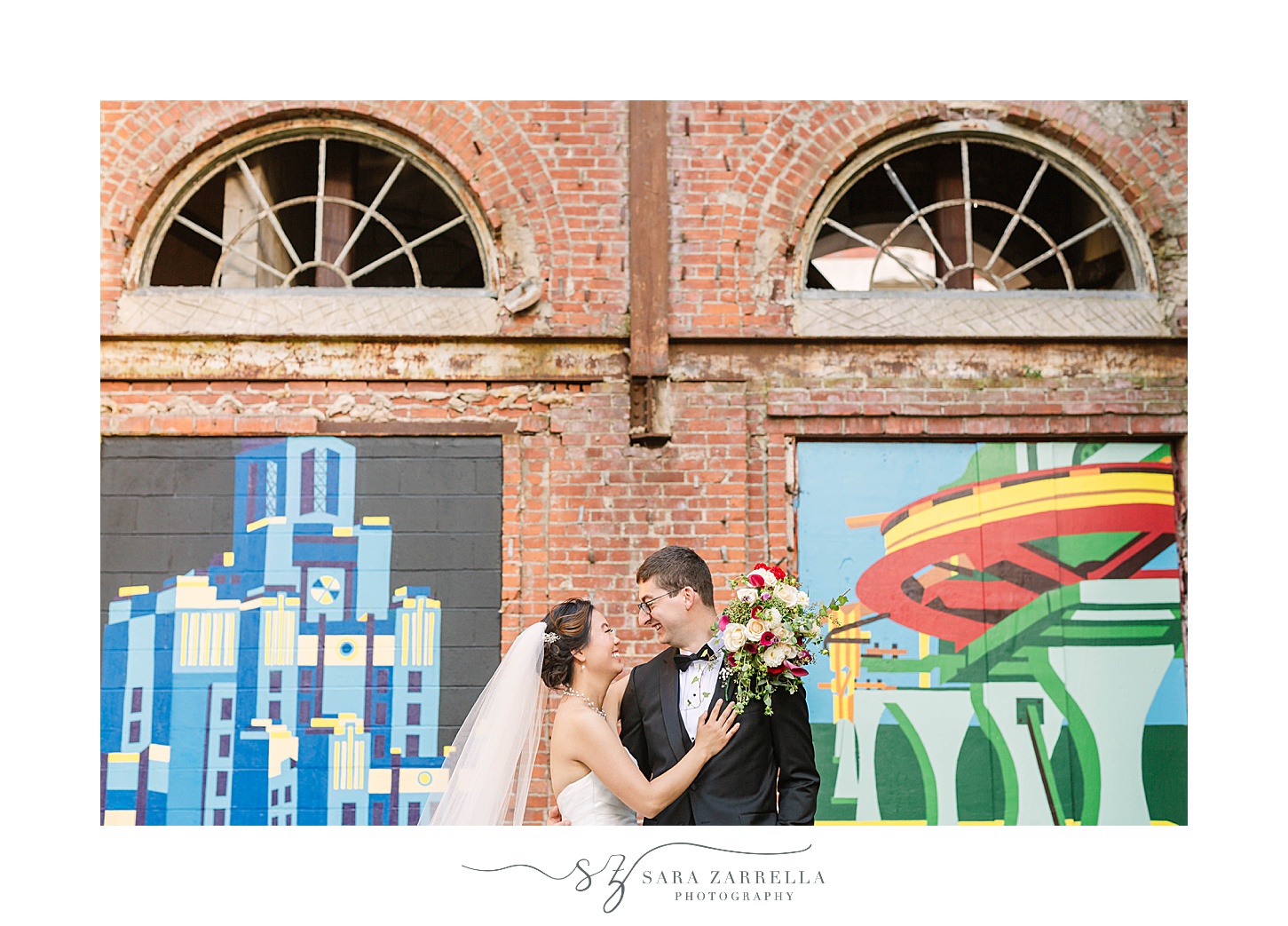 newlyweds pose by murals in Downtown Providence