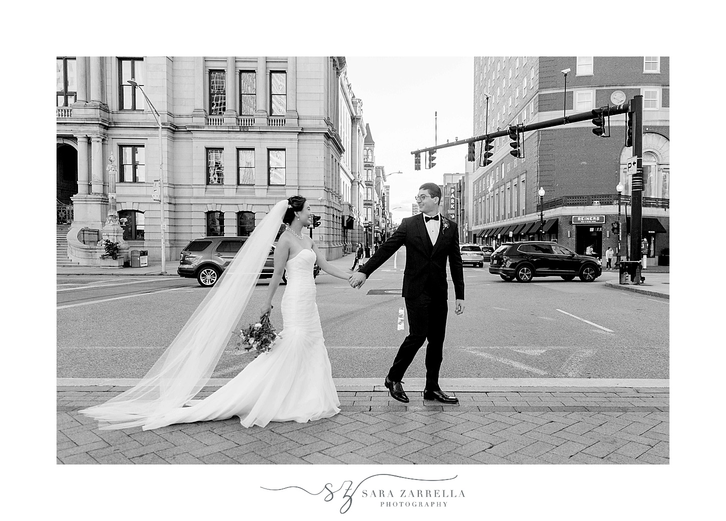 newlyweds walk through street in Downtown Providence