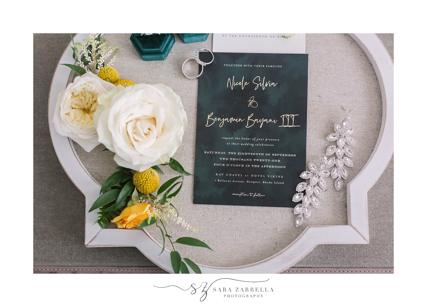 stationery sits on tray with white and yellow flowers 
