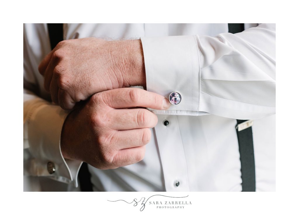 groom adjusts custom cufflinks before Hotel Viking wedding 