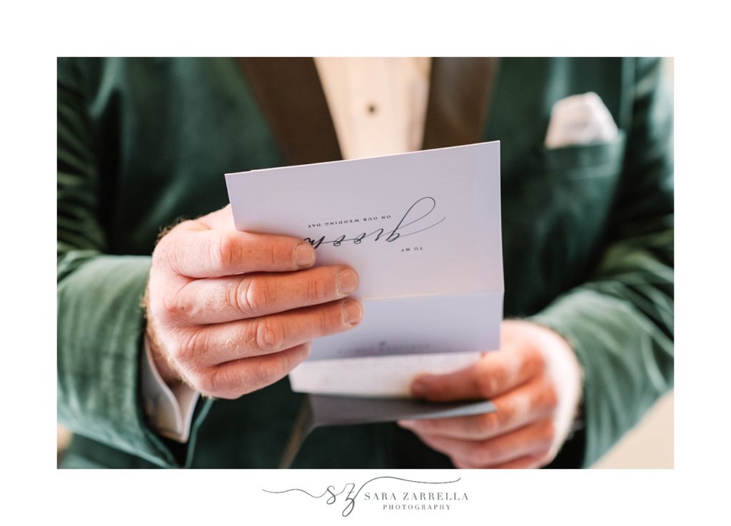groom in green velvet jacket reads letter 