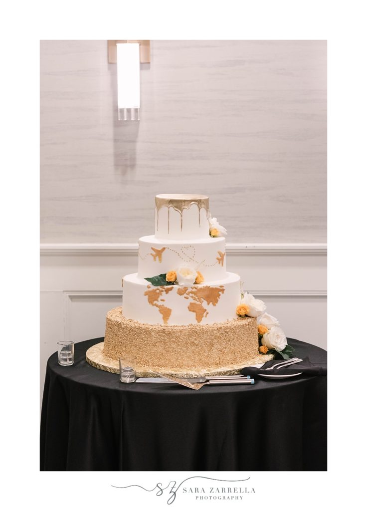 tiered wedding cake with gold globe details 