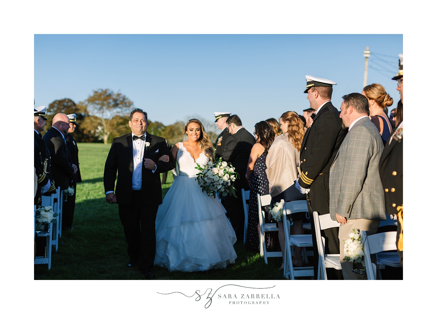 bride walks up aisle during Newport Navy Officers’ Club wedding ceremony 