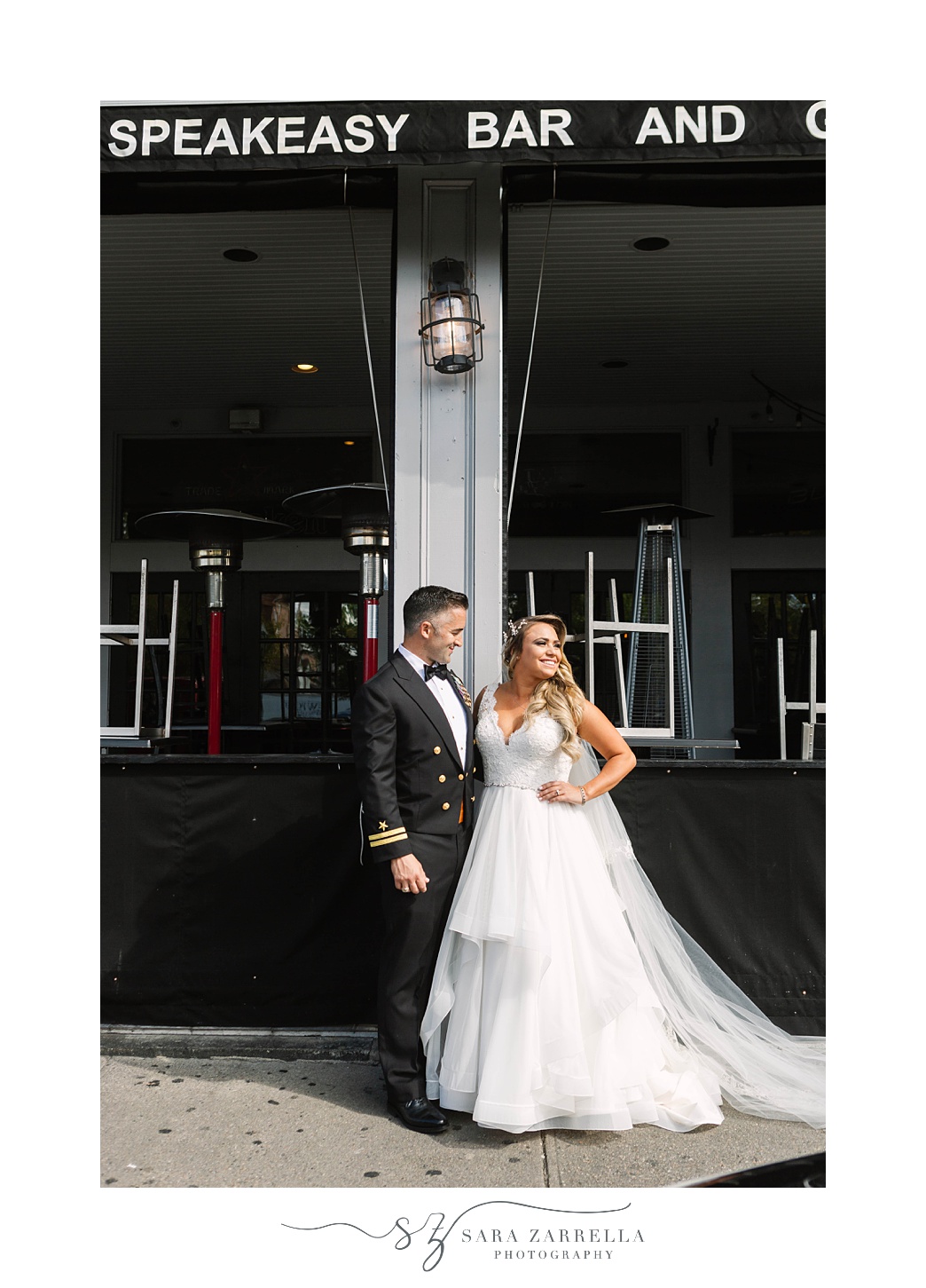 bride and groom pose outside bar in Newport RI